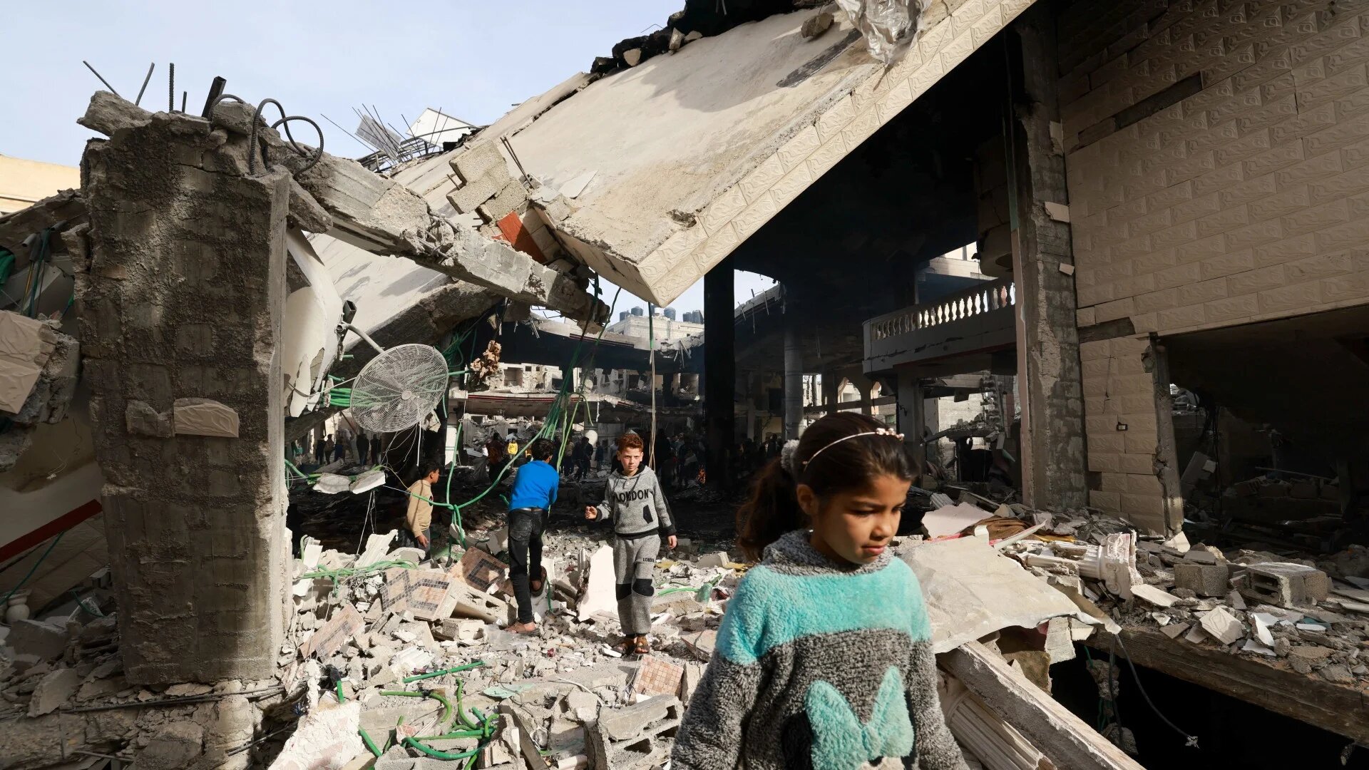 People inspect the damage in the rubble of a mosque following Israeli bombardment, in Rafah (AFP/Mohammed Abed)