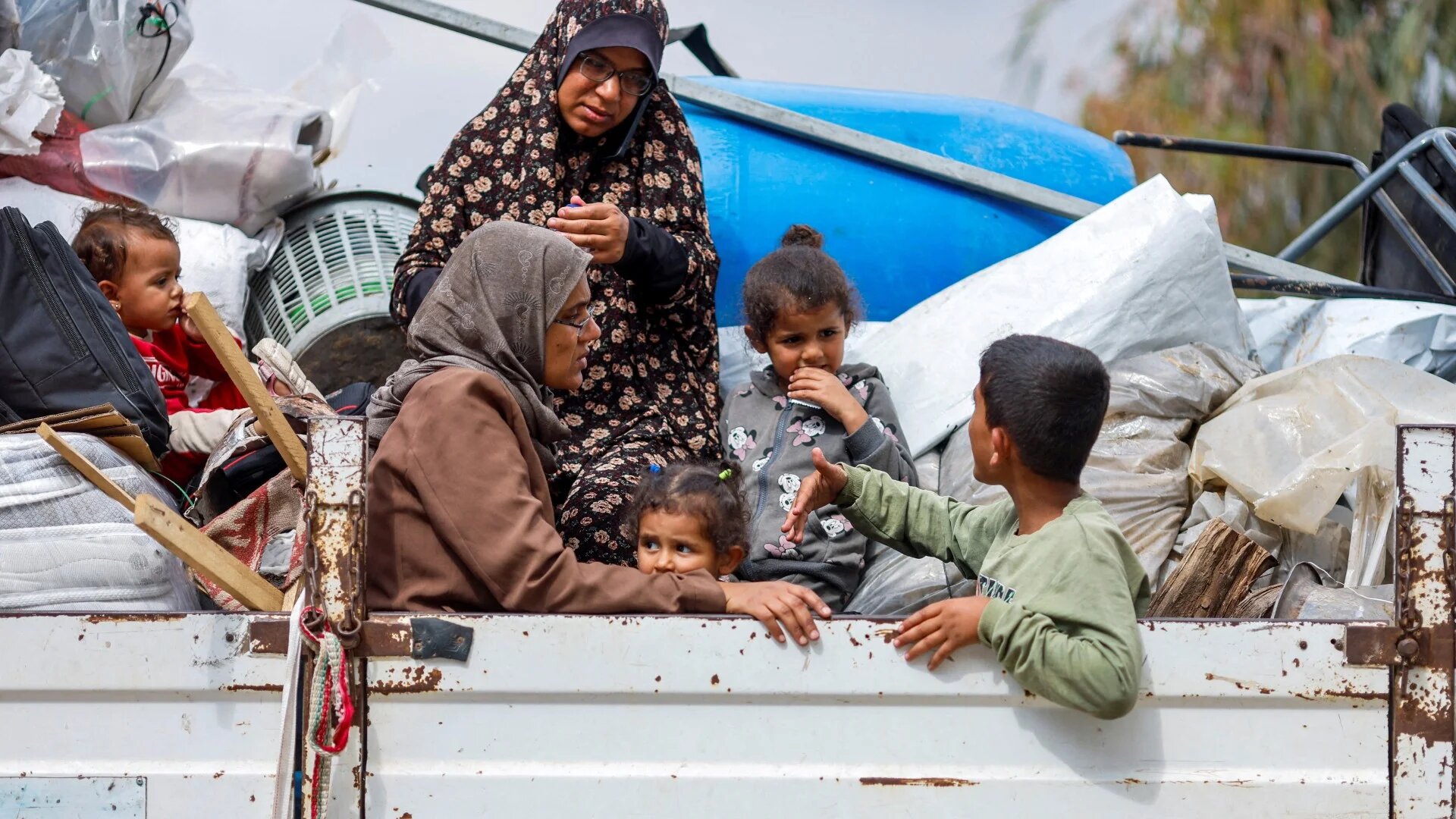 Palestinians ride on a vehicle as they flee Rafah after Israeli forces launched a ground and air operation in the eastern part of the southern Gaza City, 13 May 2024 (Reuters/Mohammed Salem) 