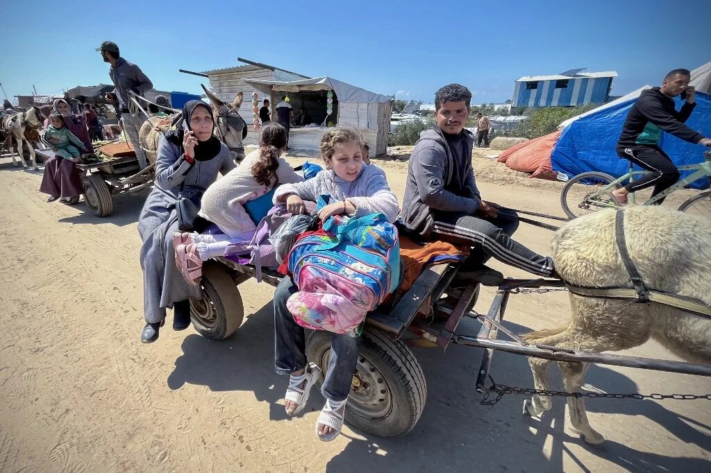 Palestinians set out to Khan Younis with their belongings, from Rafah's Tel al-Sultan area after it was encircled by Israeli forces on 23 March 2025 (AFP)