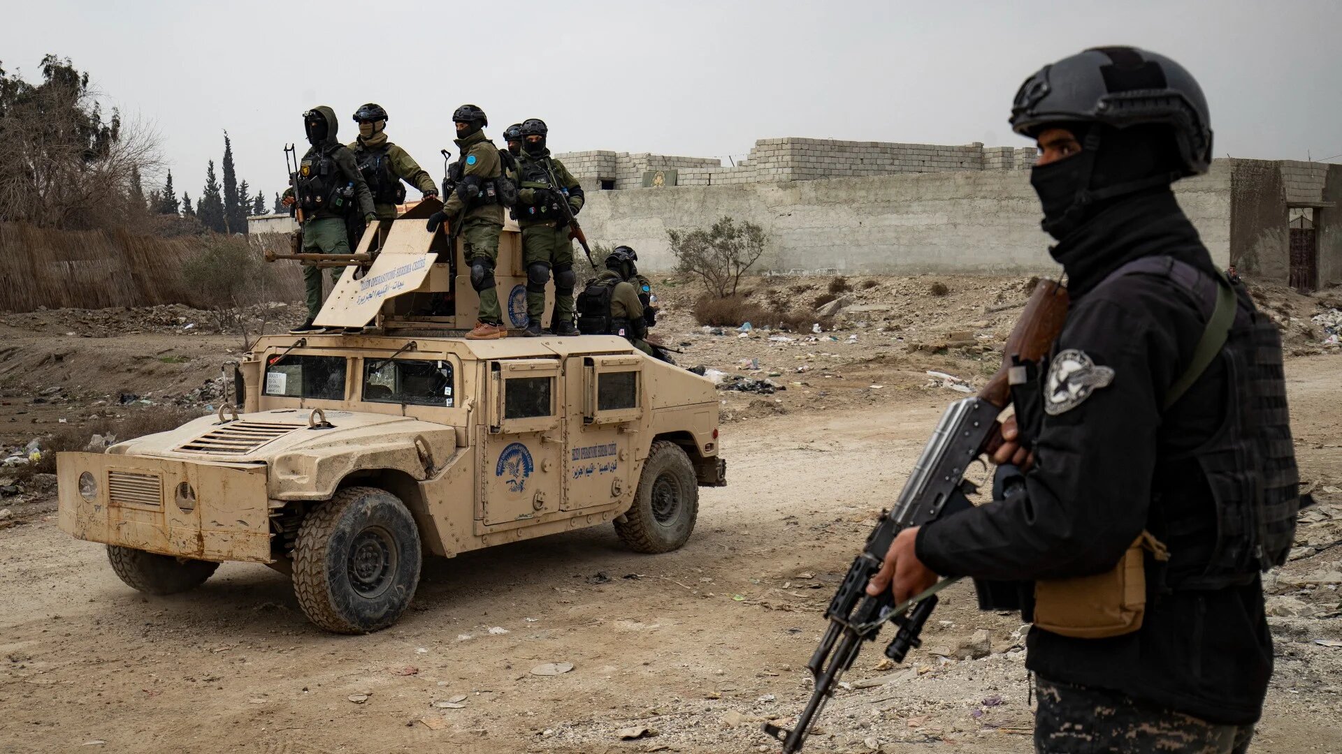 Syrian Kurdish security forces deploy during a raid against suspected Islamic State group fighters in Raqqa, the militant group's former de-facto capital in Syria, on 28 January 2023 (AFP)