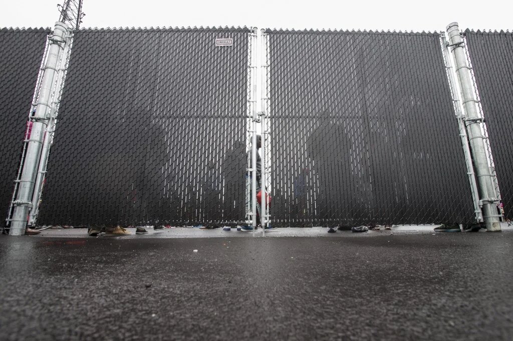 Refugees who crossed into Canada from the US illegally wait in a temporary detention centre in Blackpool, Quebec on 5 August 2017.