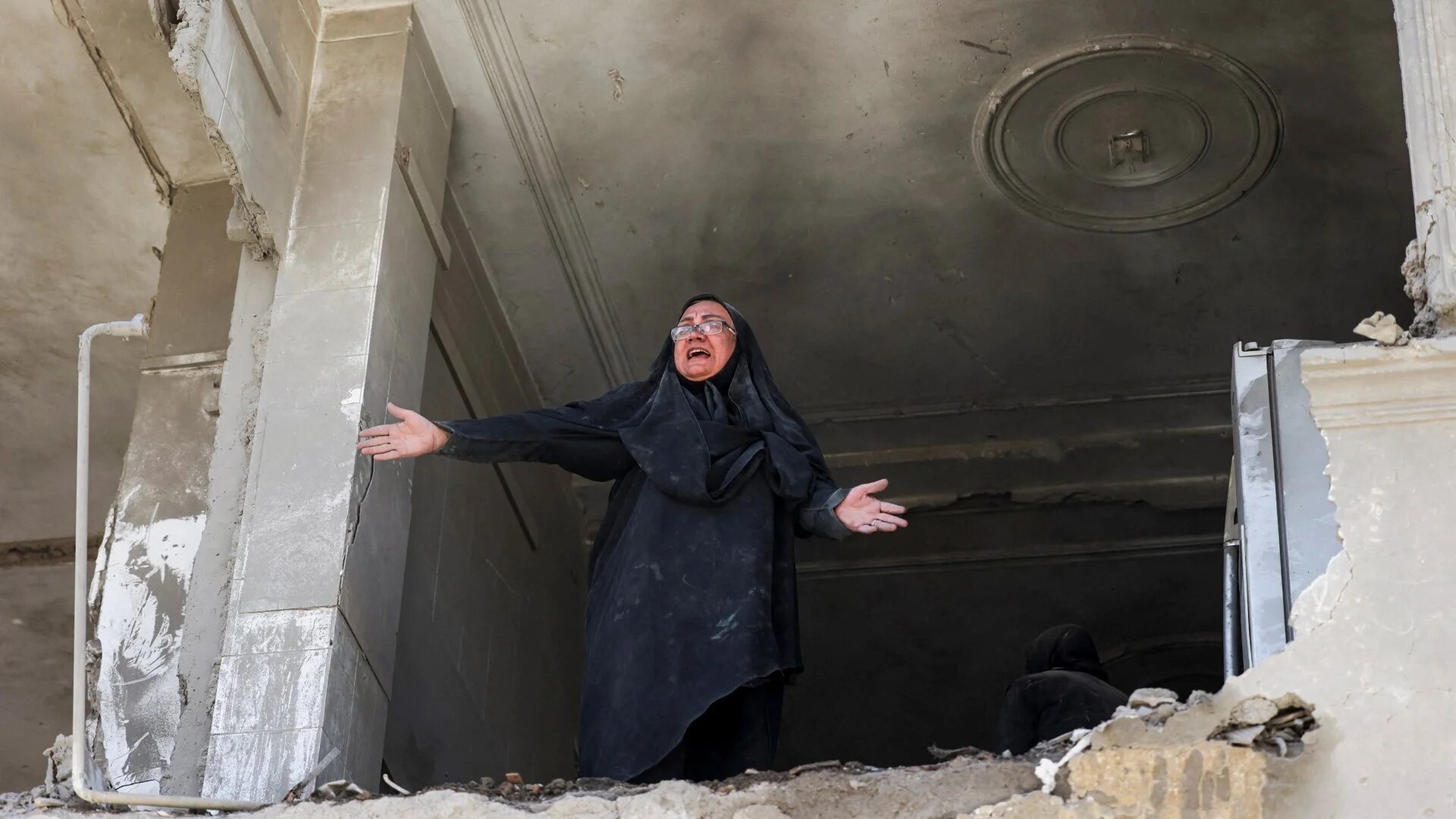 A woman reacts inside her brother's home, which was damaged by a strike, as the U.S.-Israeli conflict with Iran continues, in Tehran, Iran, March 30, 2026. Majid Asgaripour/WANA (West Asia News Agency) via REUTERS ATTENTION EDITORS - THIS PICTURE WAS PROVIDED BY A THIRD PARTY TPX IMAGES OF THE DAY