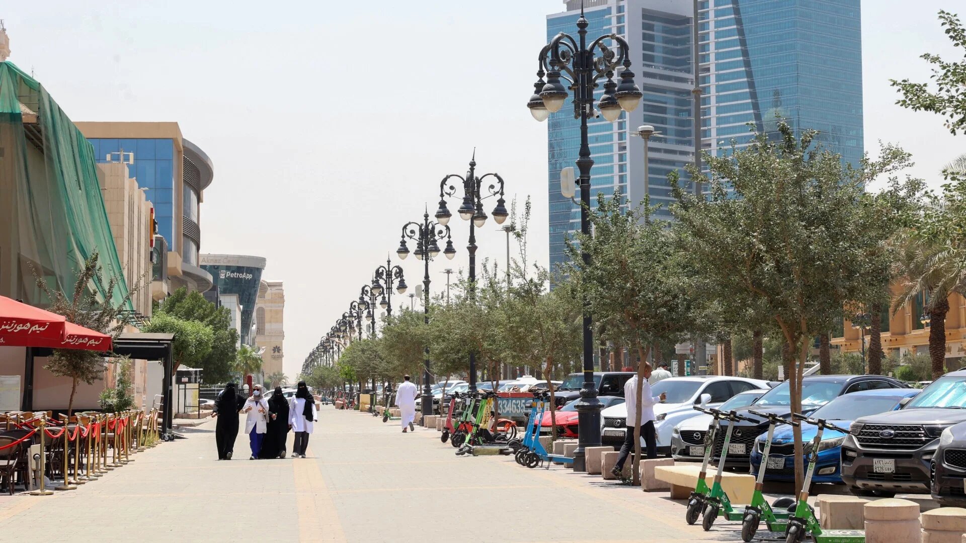 People walk down al-Tahliya main street in Riyadh on 1 May 2025 (AFP/Fayez Nureldine)