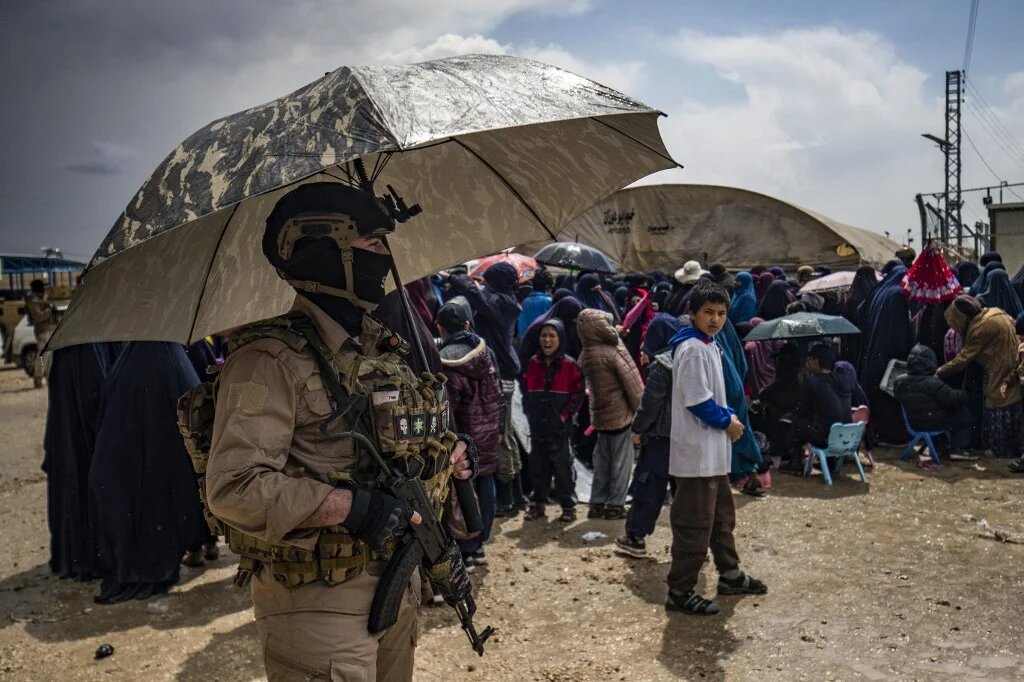 Members of Syria's Kurdish Internal Security Police Force, also known as Asayesh, and the Kurdish-led Syrian Democratic Forces (SDF) stand guard at al-Roj camp in Syria's northeastern Hasakah province on 5 April, 2025. (AFP)
