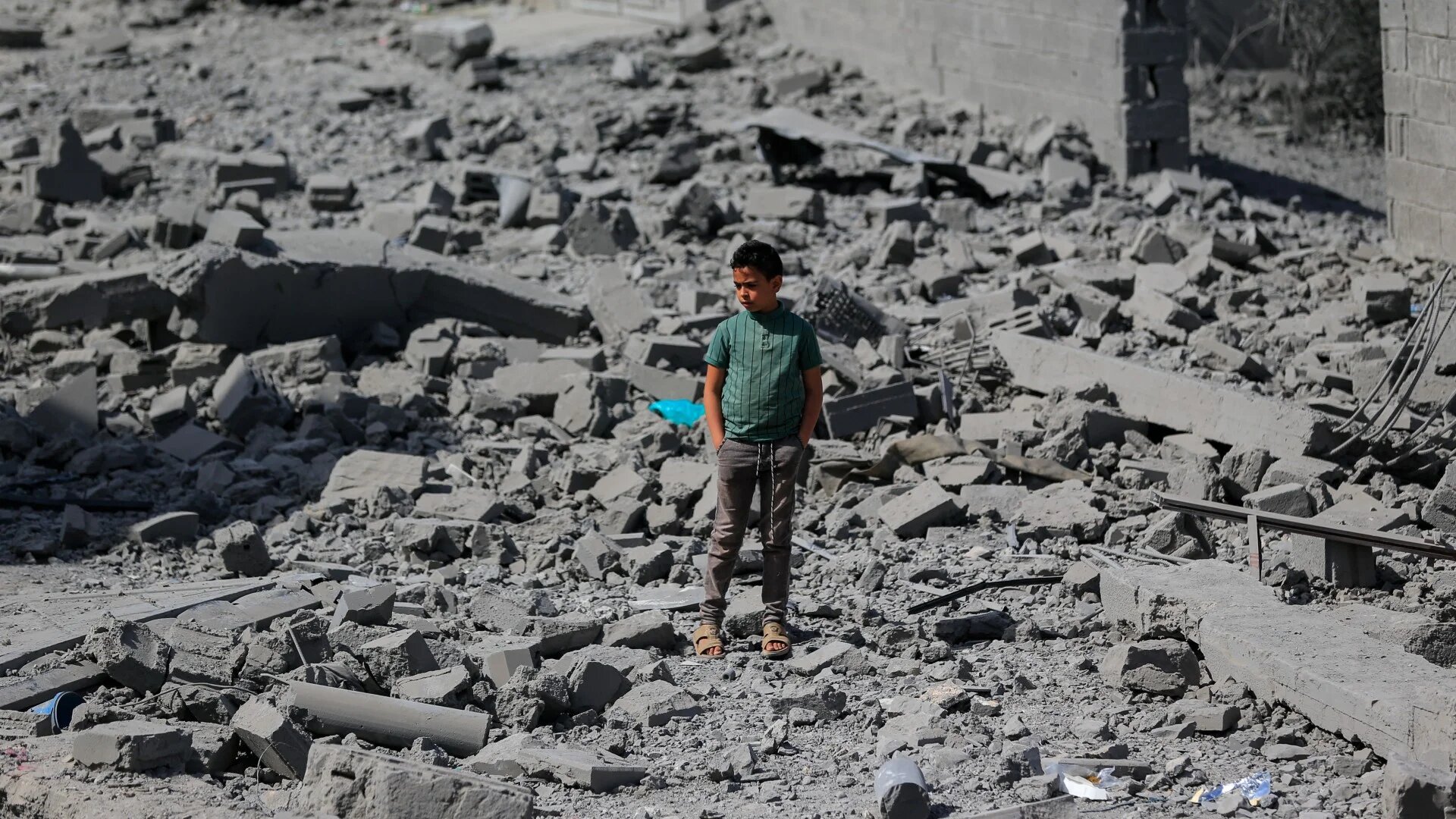 A young boy stands amid the destruction following overnight US strikes in the Yemeni capital Sanaa on 27 April 2025 (AFP/Mohammed Huwais)