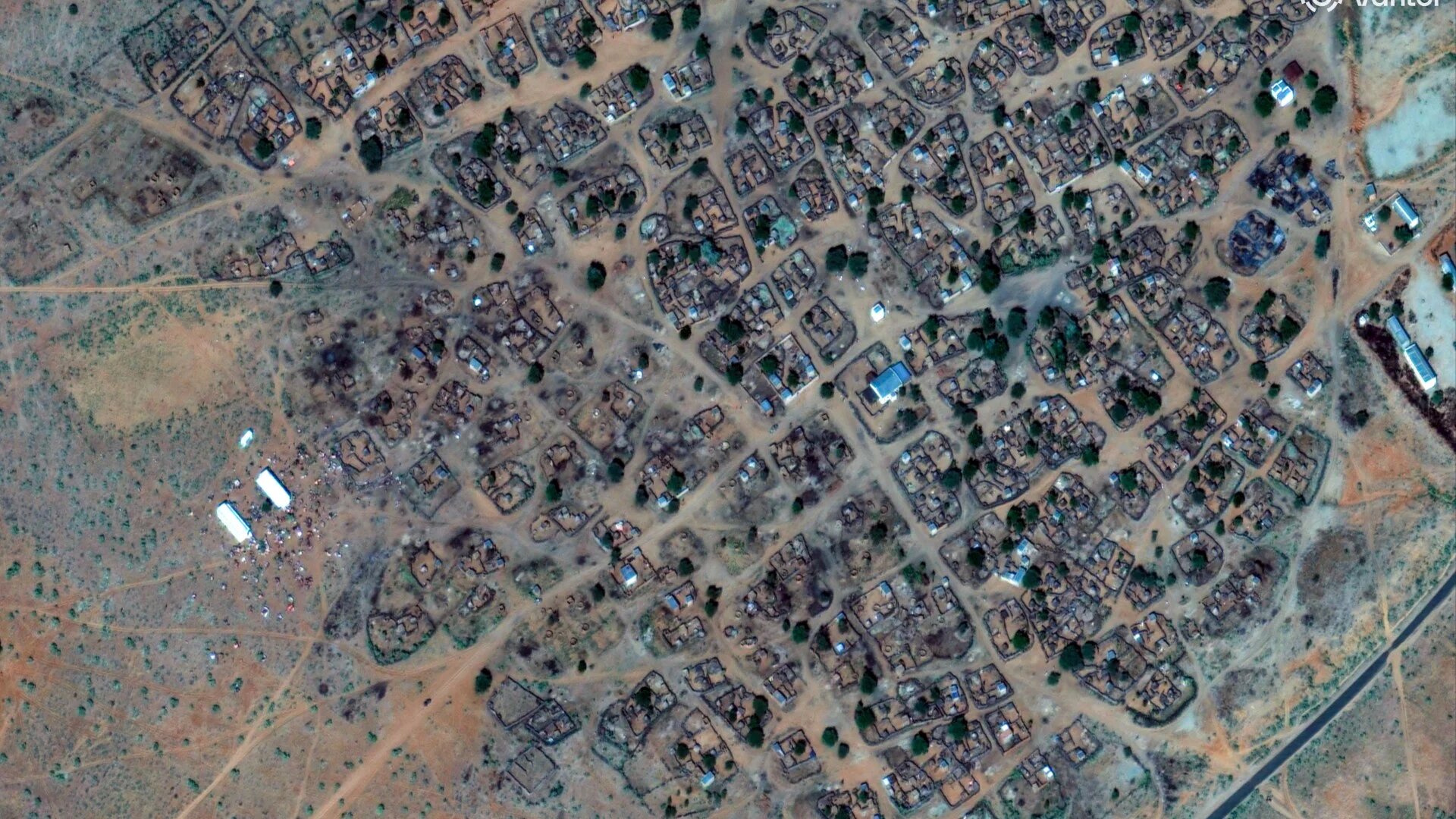 This handout satellite image by Vantor taken on 30 October 2025 shows people gathering on the outskirts of a village located northwest of El-Fasher (AFP/Handout/©2025 Vantor)