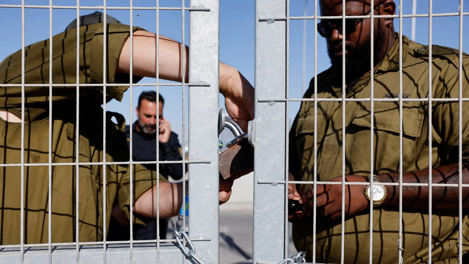 Soldiers lock a gate at the Sde Teiman detention facility, after Israeli military police arrived as part of an investigation into the abuse of a Palestinian detainee, on 29 July 2024 (Amir Cohen/Reuters)