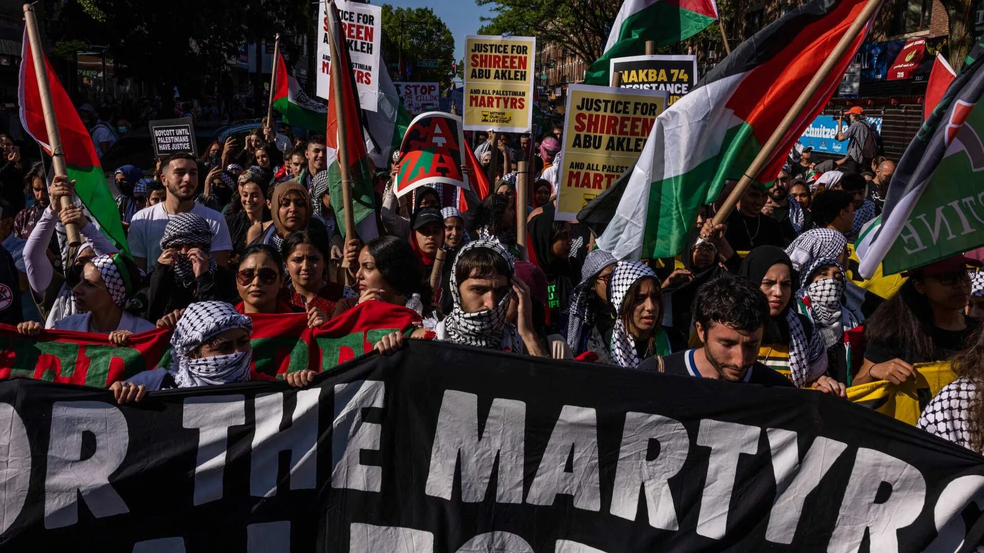 Protestors hold signs calling for justice for Shireen Abu Akleh on 15 May 2022 in the Bay Ridge neighborhood of the Brooklyn borough of New York City.