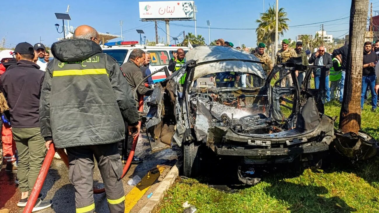 Lebanese army, security forces, and civil defence first responders inspect the remains of the destroyed vehicle following Israel's strike on Sidon, Lebanon on 17 February 2025 (AFP)