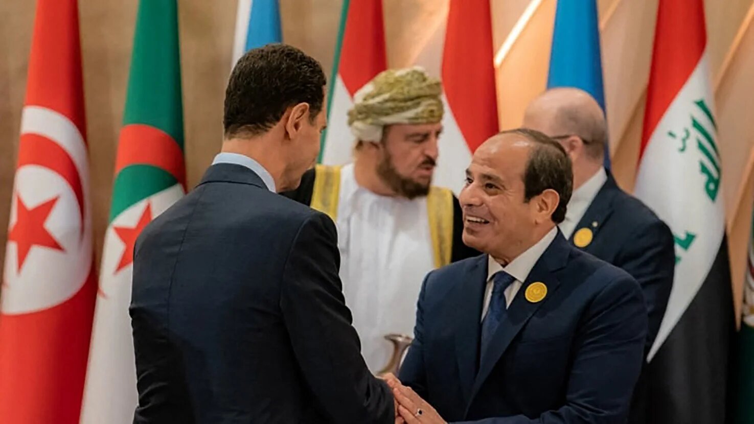 Syrian President Bashar al-Assad greets Egyptian President Abdel Fattah el-Sisi ahead of the 32nd Arab League Summit in Jeddah on 19 May 2023 (AFP)