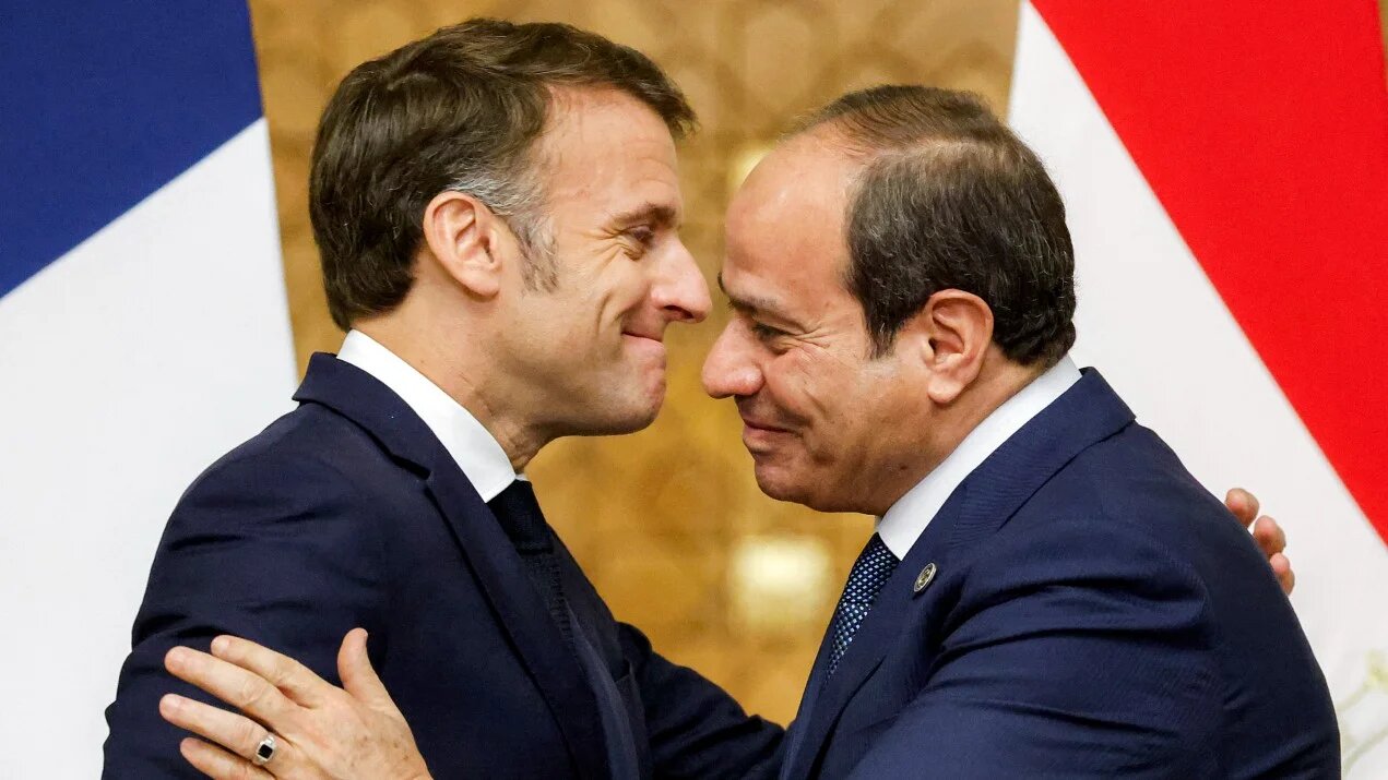 Egypt's President Abdel Fattah al-Sisi (R) and French President Emmanuel Macron (L) embrace and shake hands during their meeting at the Presidential Palace in Cairo on April 7, 2025.
