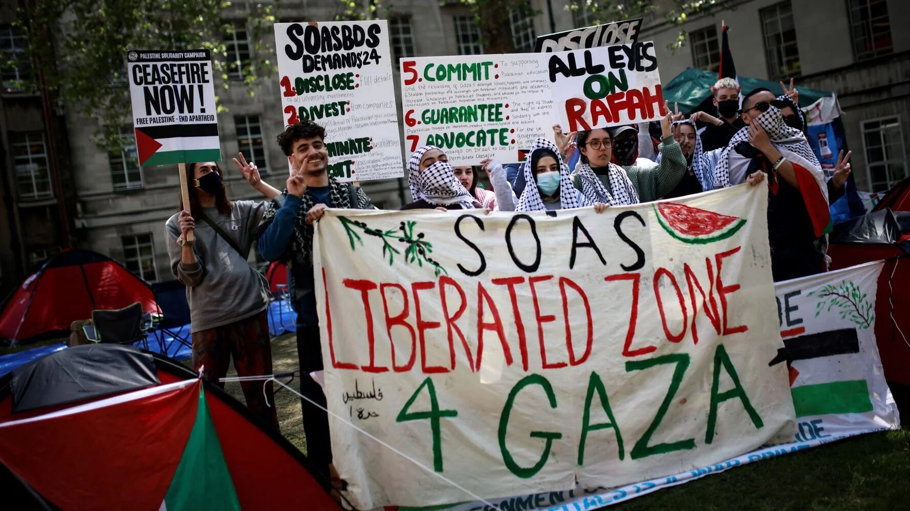 Students hold placards during a pro-Palestine protest at the School of Oriental and African Studies (SOAS) in May 2024 (AFP/Benjamin Cremel)