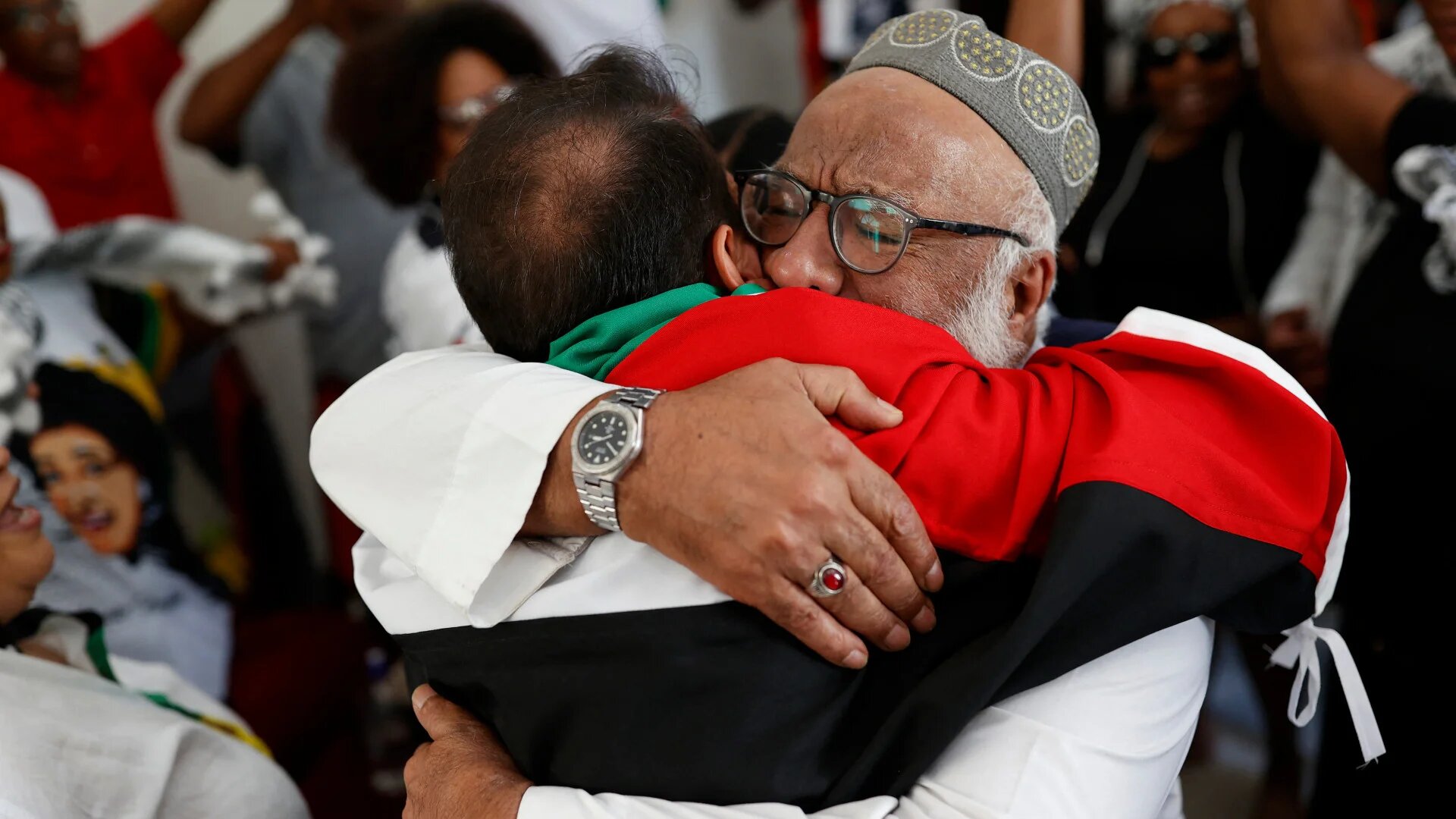 Pro-Palestine supporters react in celebration after watching the International Court of Justice delivering its decision following a hearing of the case against Israel brought by South Africa in The Hague at the Embassy of Palestine in Pretoria on 26 January 2024 (Phill Magakoe / AFP)