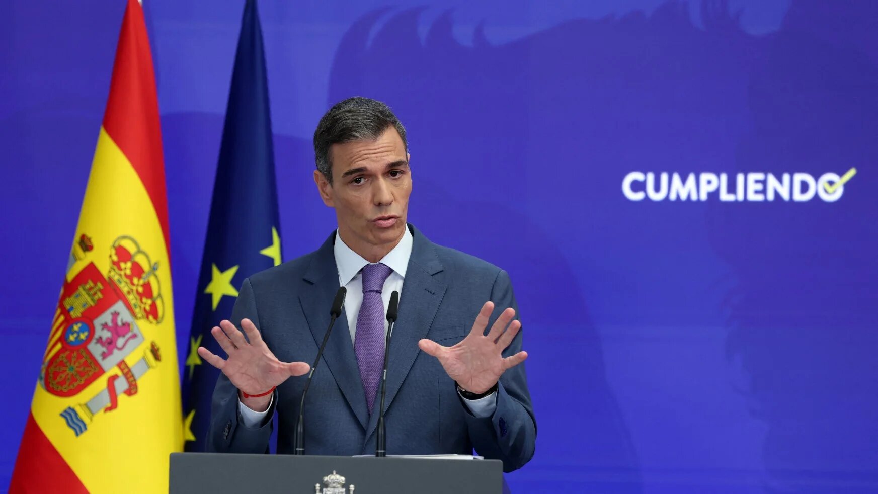 Spain's Prime Minister Pedro Sanchez speaks next to the word reading 'accomplishing' during a biannual press conference at La Moncloa Palace in Madrid on July 28, 2025. Pierre-Philippe MARCOU / AFP