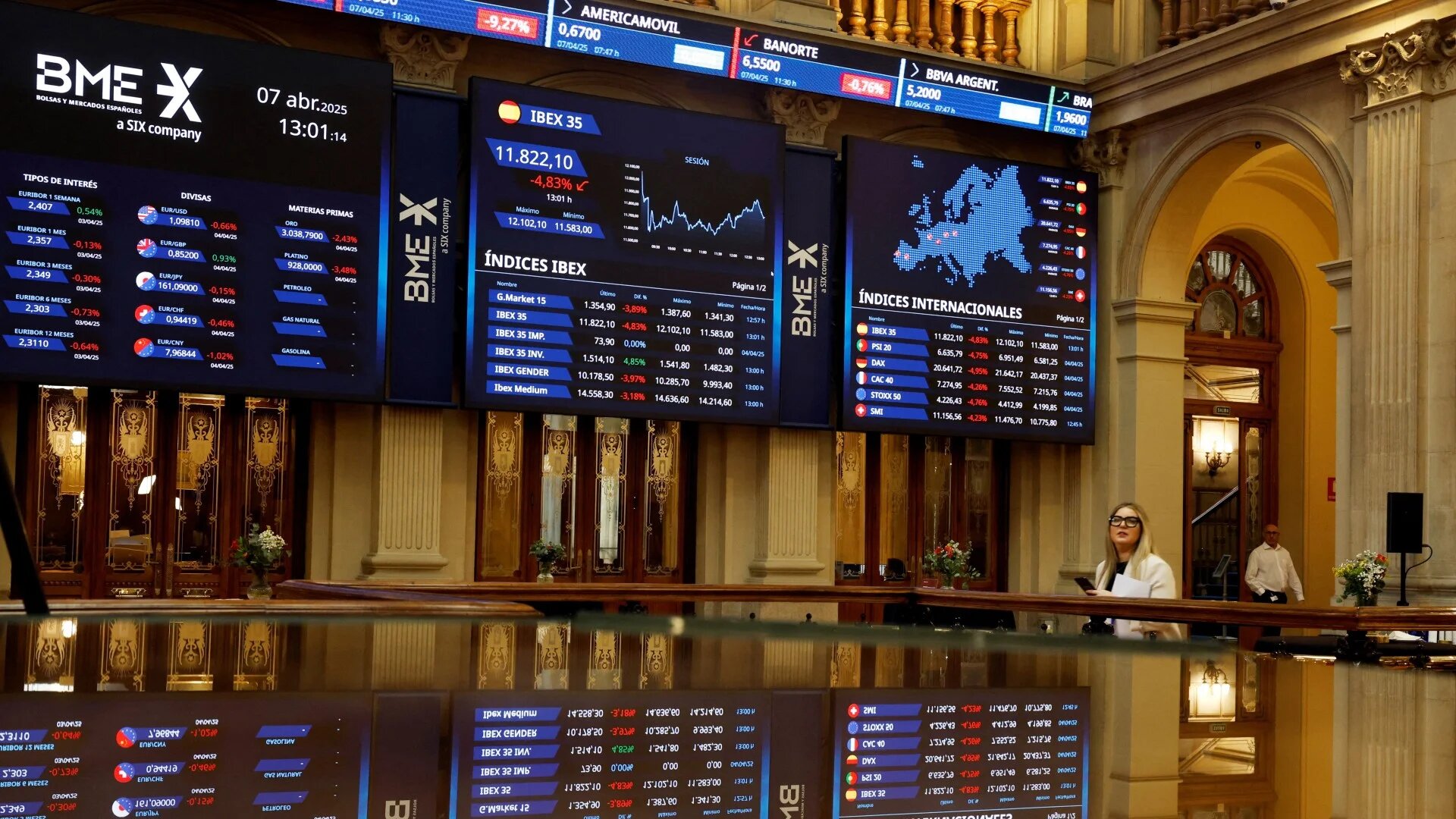 Electronic boards display stock information at the stock exchange in Madrid, Spain, on 7 April 2025 (Reuters/Susana Vera)