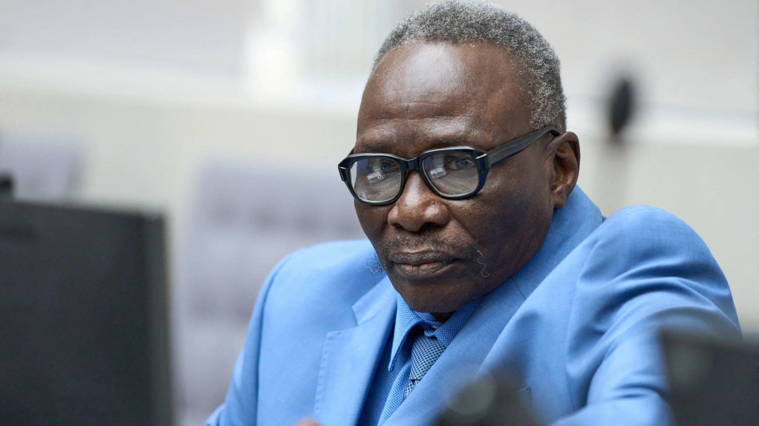 Ali Muhammad Ali Abd al-Rahman, for leader of the Sudanese Janjaweed militia, waits to hear the verdict of the International Criminal Court, in The Hague, Netherlands, 9 December 2025 (Reuters)