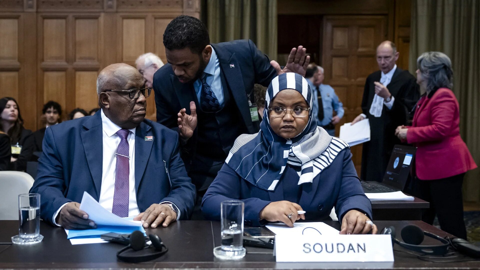 Muawia Osman (left), Sudan's acting minister of justice, and Sudanese ambassador to the Netherlands Omaima Alsharief wait for the start of a hearing before the International Court of Justice in The Hague, on 10 April 2025 (AFP/ANP/Remko de Waal)