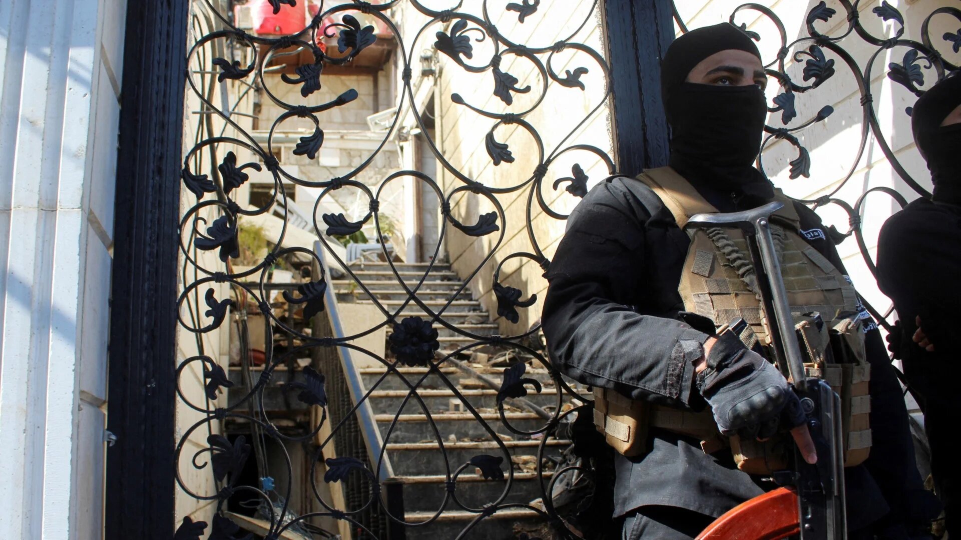 A member of the Syrian security forces stands guard at a damaged site, after Israel carried out an air strike on Damascus 13 March (Reuters/Firas Makdesi)