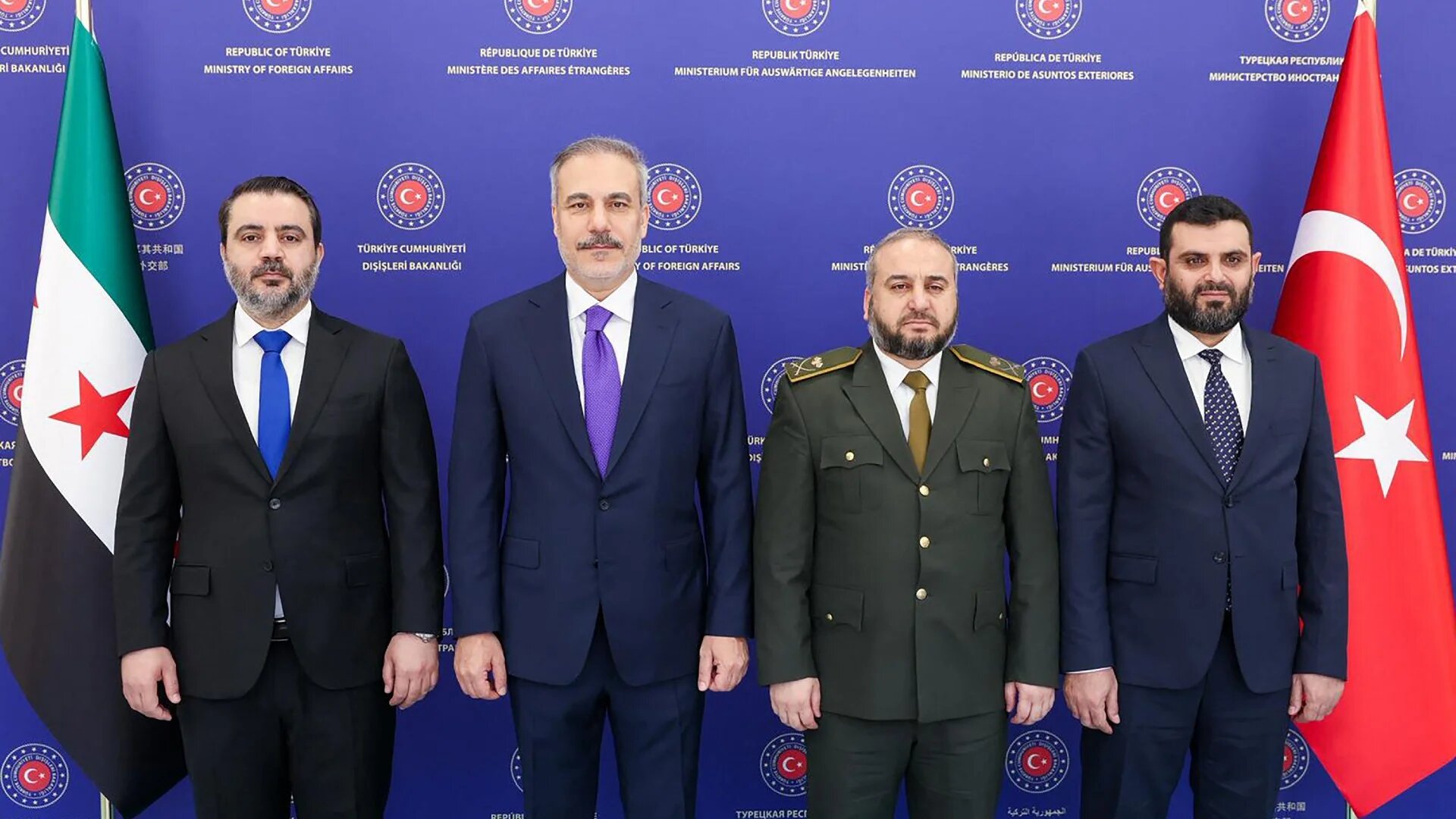 Turkish Foreign Minister Hakan Fidan (2nd L) next to Syrian Foreign Minister Asaad al-Shaibani (L), Syrian Defence Minister Murhaf Abu Qasra (2nd R) and Head of Syrian Intelligence Hussein al-Salama in Ankara on 13 August 2025 (handout/Turkish foreign ministry/AFP)