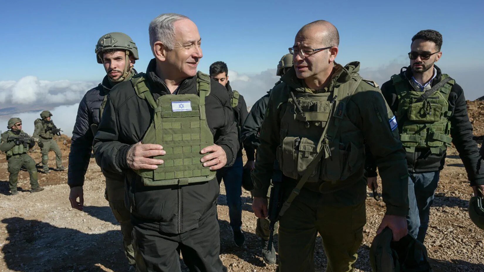 Israeli Prime Minister Benjamin Netanyahu walking with his army in the Israeli-occupied Mount Hermon (Handout/Government Press Office/AFP)