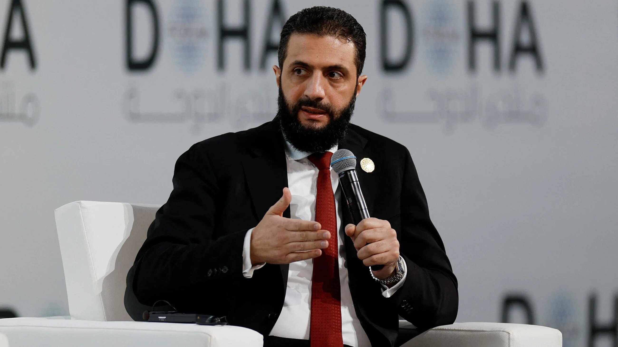 Syrian President Ahmed al-Sharaa speaks as he attends the 23rd edition of the annual Doha Forum, in Doha, 6 December 2025 (Reuters)