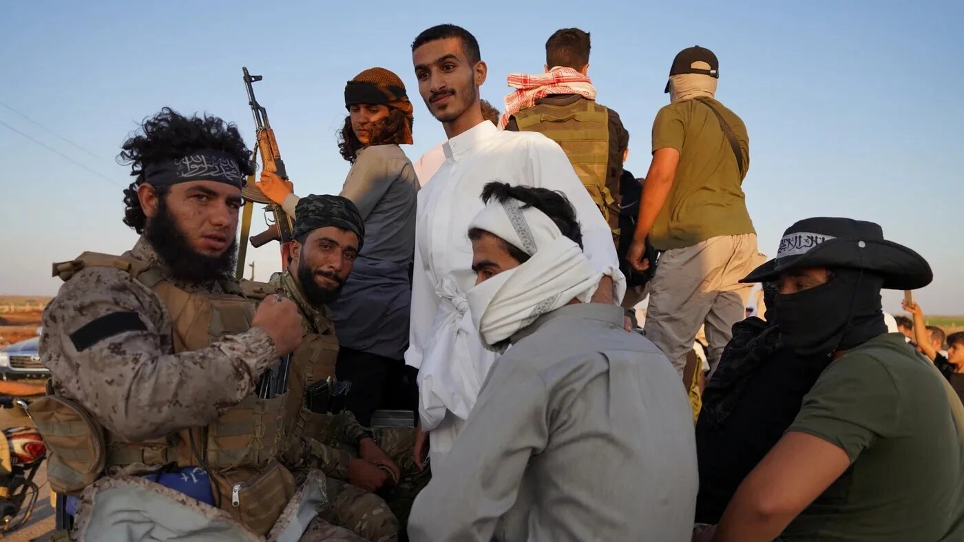 Bedouin fighters are pictured after days of clashes against Druze factions in Syria's Sweida province on 20 July 2025 (Reuters/Karam al-Masri)