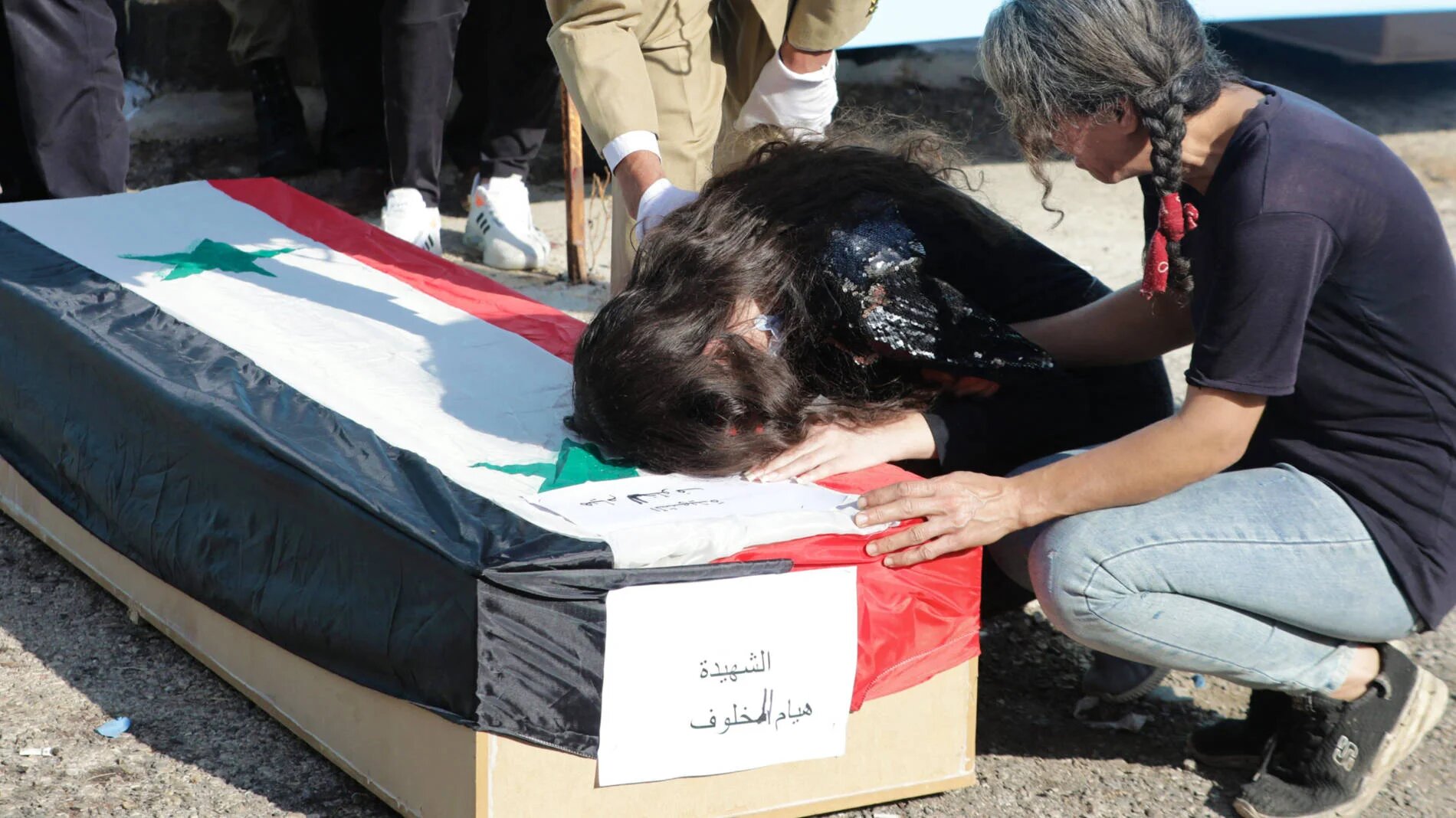 Relatives mourn at the funeral of the victims of a drone attack on a military academy in Homs, Syria, on 5 October 2023 (AFP)