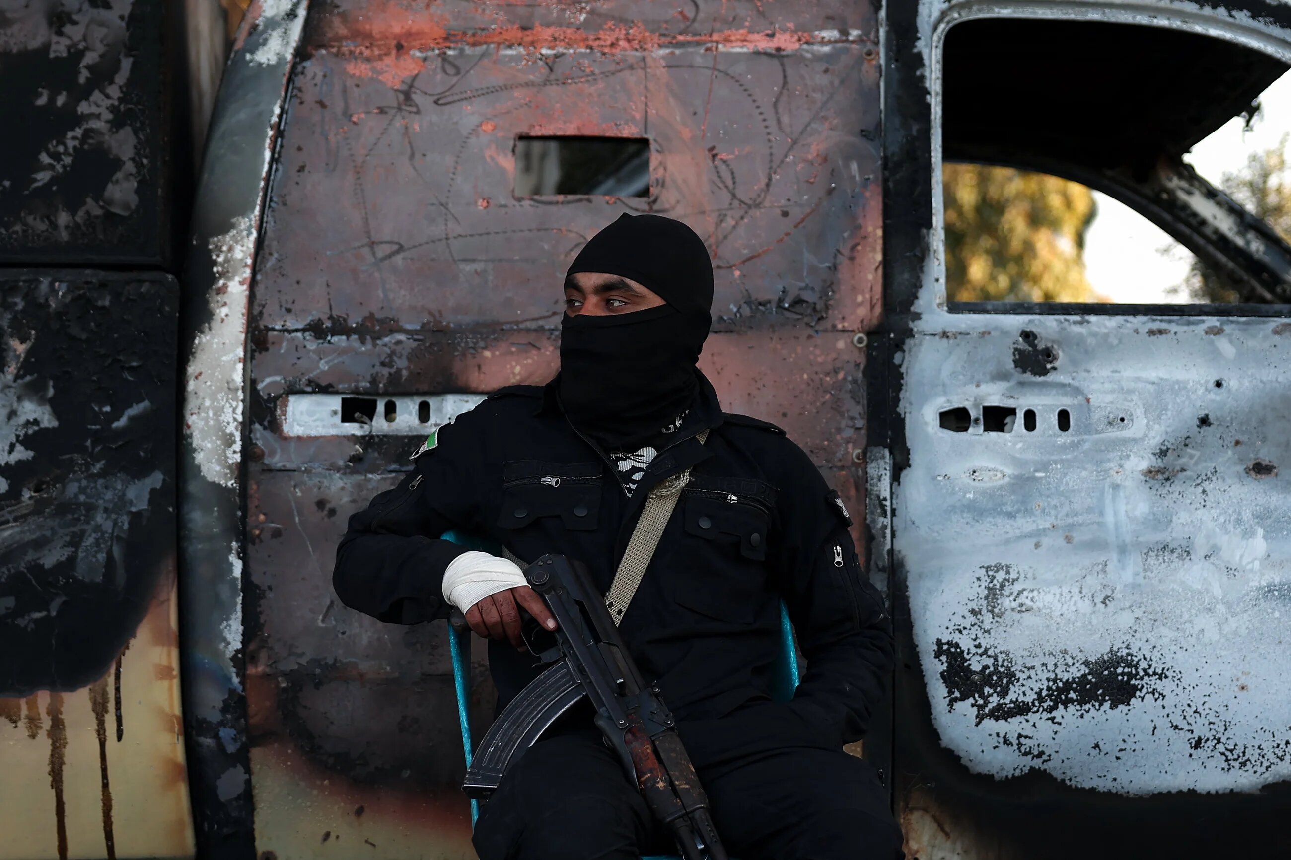 A member of the security forces loyal to the current Syrian government guards a checkpoint in the town of Hmeimim on 11 March 2025 (AFP/Omar Haj Kadour)