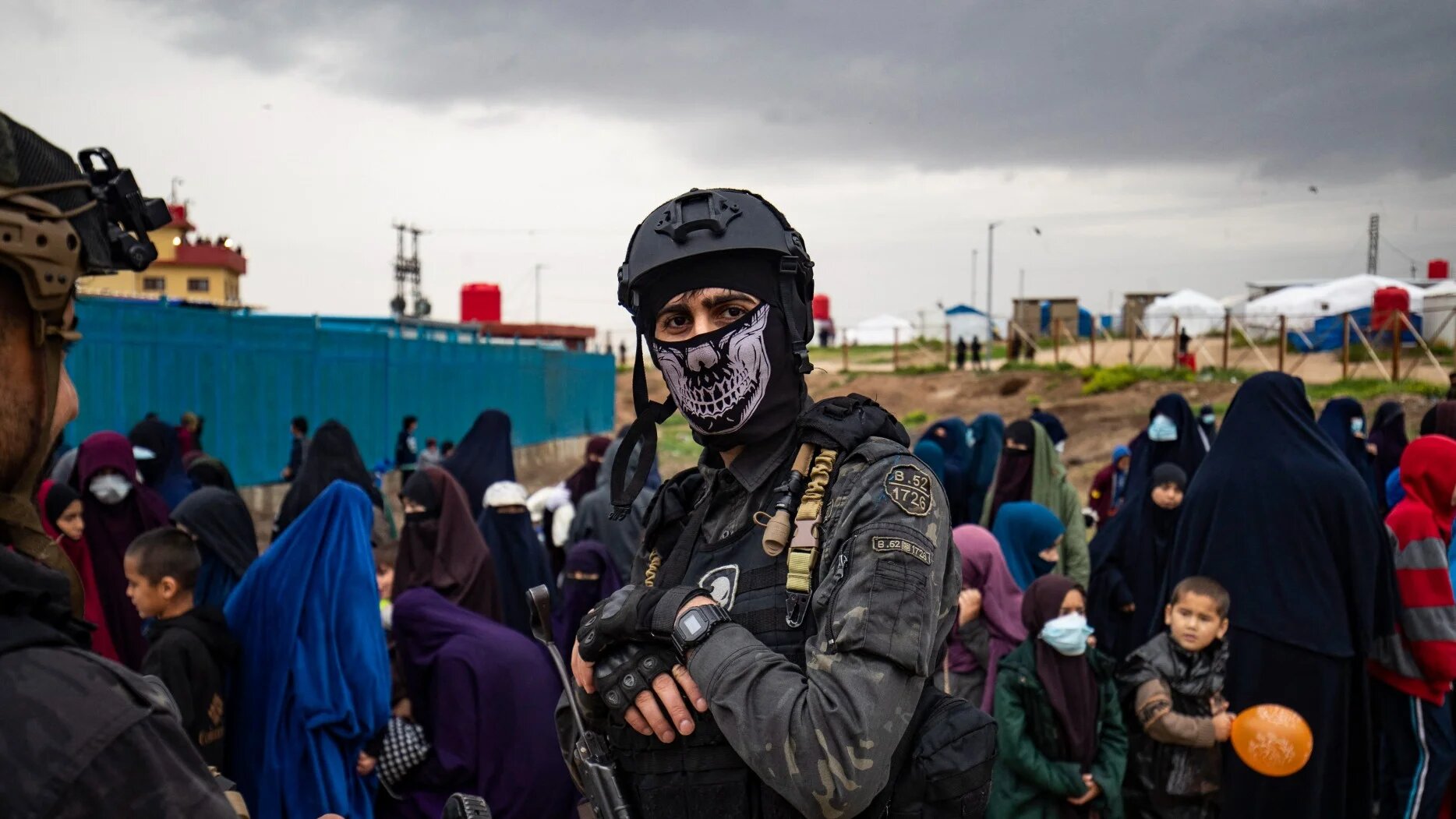 A fighter poses for a picture as others stand guard during a joint security operation for Syria's Kurdish Internal Security Police Force, also known as Asayesh, and the Kurdish-led Syrian Democratic Forces (SDF) at Camp Roj, where foreign relatives of people suspected of belonging to the Islamic State (IS) group are held, in the countryside near al-Malikiyah (Derik) in Syria's northeastern Hasakah province on 5 April 2025 (AFP)