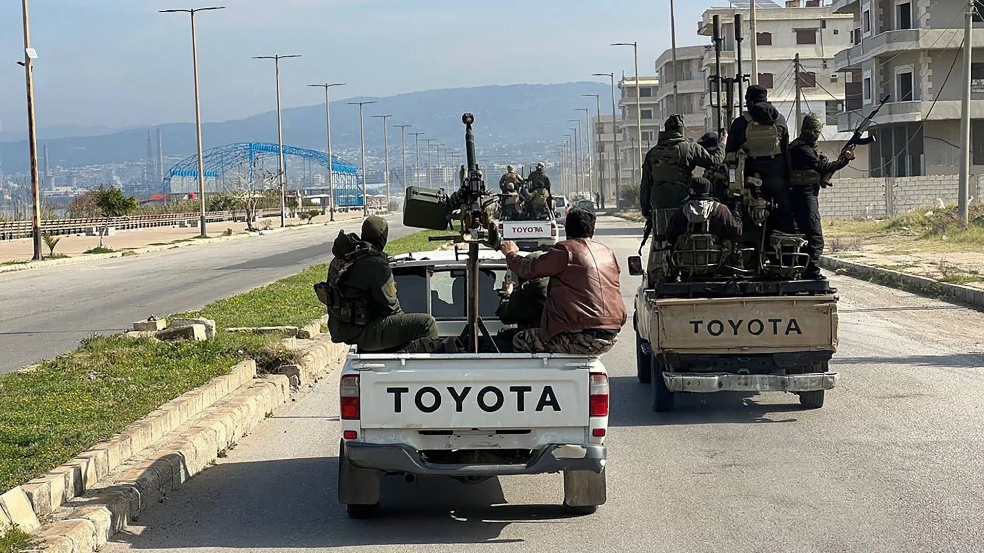 Members of the Syrian security forces enter the western city of Baniyas in Syria's coastal Tartous province on 7 March 2025 (AFP/Sana news agency)
