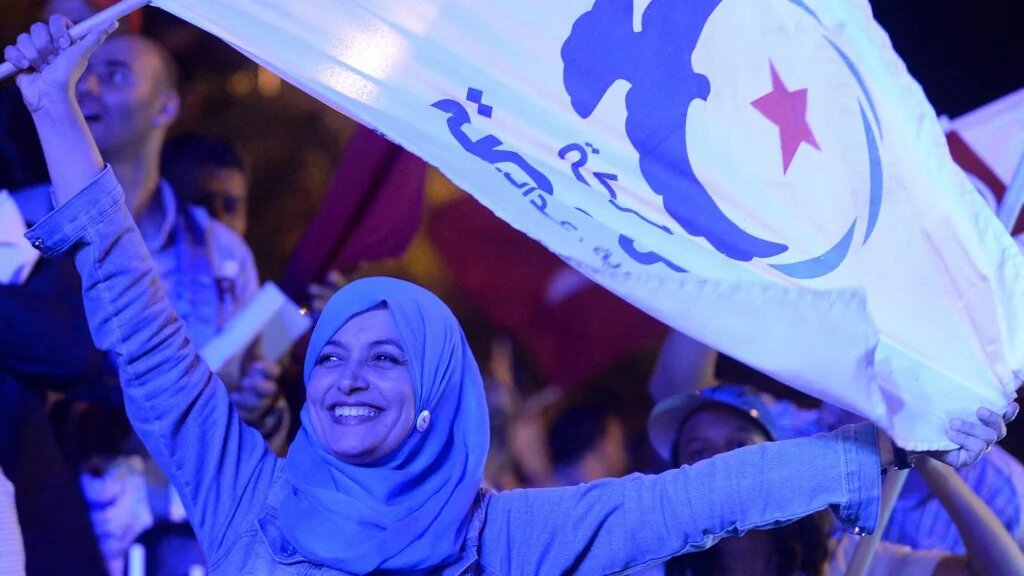 A supporter waves a flag of the Islamist Ennahda party in Tunis in October 2014 (Fadel Senna/AFP)