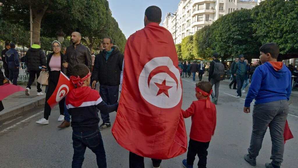 Tunisians take part in a rally marking the anniversary of the 2011 uprising in Tunis on 14 January 2020 (Fethi Belaid/AFP)