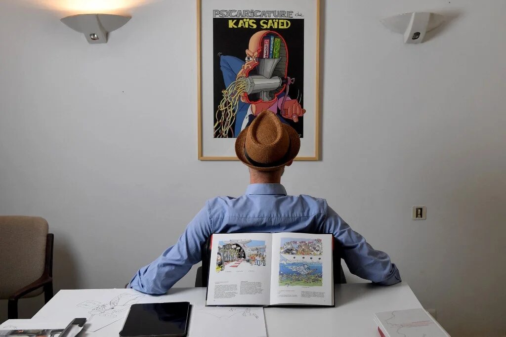 Le dessinateur qui se fait appeler par la seule lettre « Z » a demandé d’apparaître visage caché sur les photos pour conserver un anonymat adopté depuis 2007 sous la dictature de Zine el-Abidine Ben Ali (AFP/Fethi Belaïd)