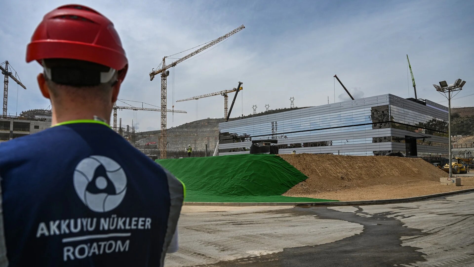 An engineer looks towards a building under construction at the Russian-built Akkuyu Nuclear Power Plant in Turkey's Mersin province on 26 April, 2023 (Ozan Kose/AFP)