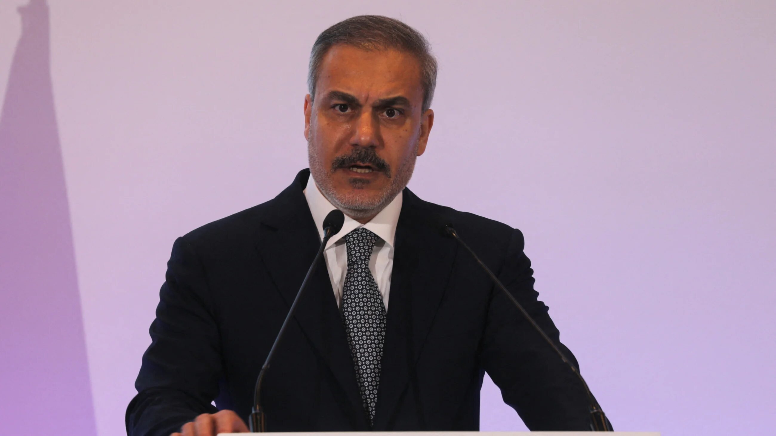 Turkish Foreign Minister Hakan Fidan speaks to the media during the Doha Forum in Qatar on 8 December 2024 (Ibraheem Abu Mustafa/Reuters)