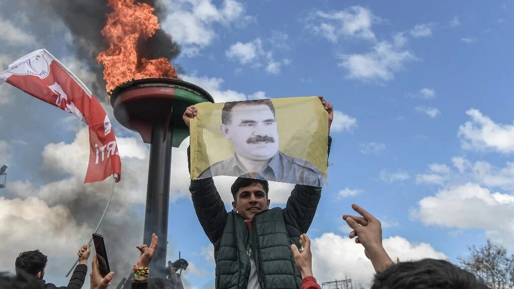 A man holds a portrait of jailed PKK leader Abdullah Ocalan in Diyarbakir, southeastern Turkey, on 21 March 2025 (Ilyas Akengin/AFP)