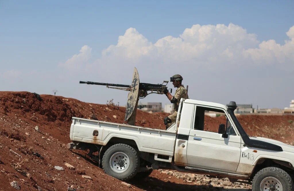 A Turkey-backed Syrian fighter mans a position in the northern Aleppo countryside on 20 August 2022 (AFP)