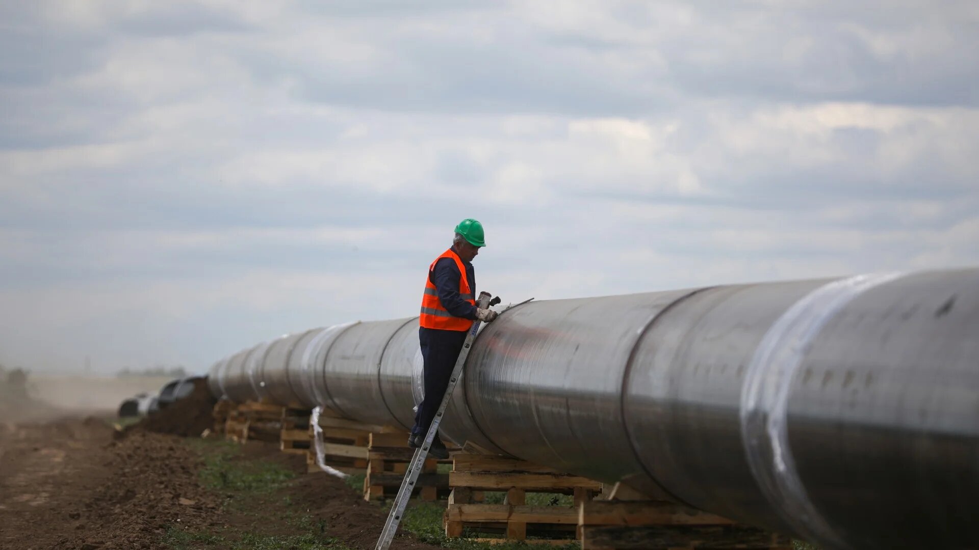 A worker is seen next to a pipe at a construction site for the extension of Russia's TurkStream gas pipeline in Letnitsa, Bulgaria, on 1 June 2020 (Reuters/Stoyan Nenov)