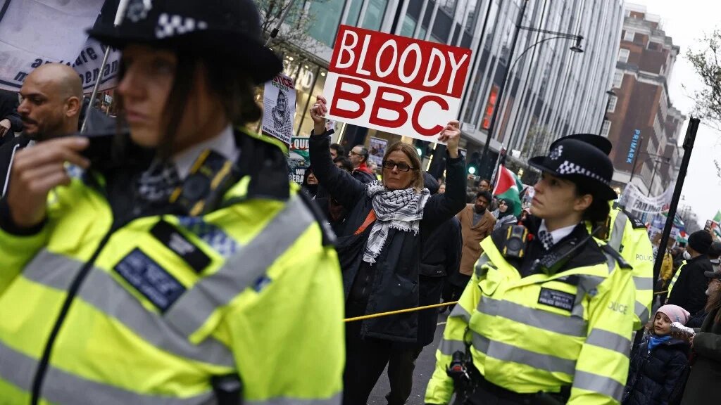 A protester holds up a placard with an anti-BBC message during a pro-Palestinian demonstration in central London on 23 March 2025 (Benjamin Cremel/AFP)