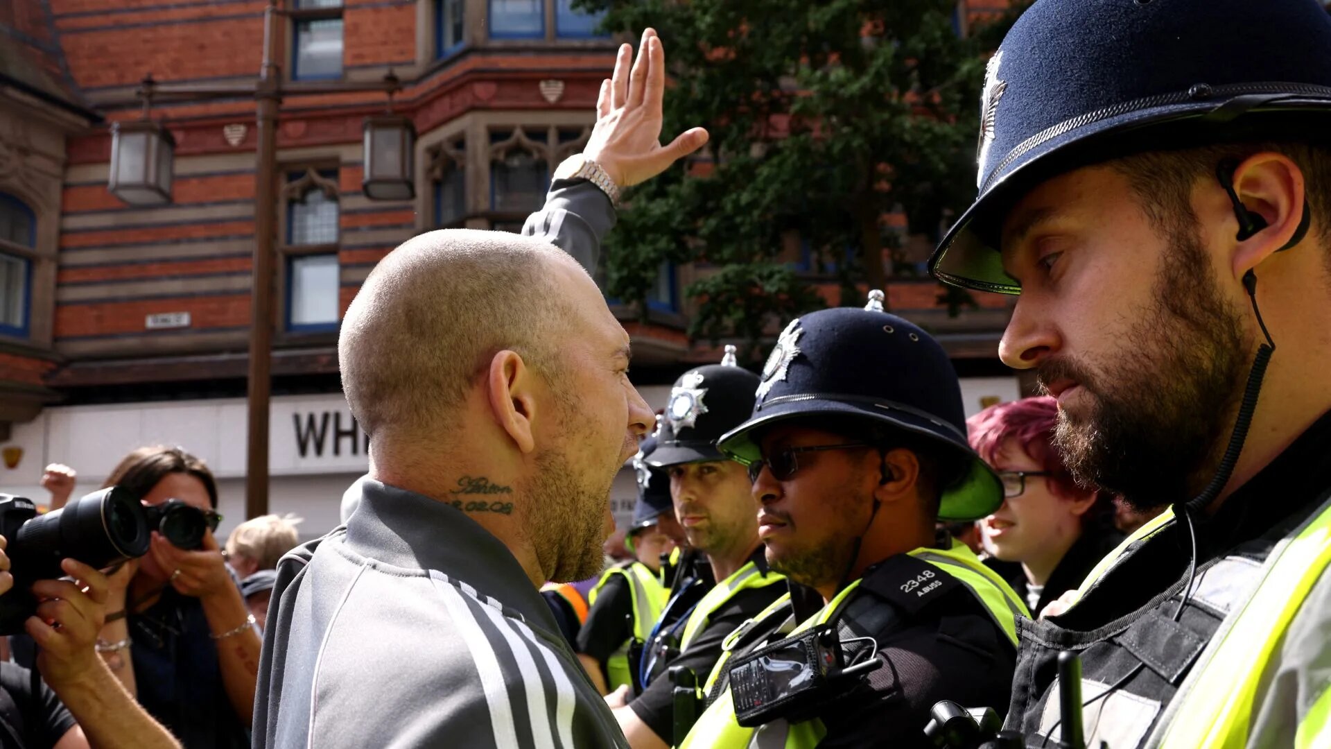 A protester gestures towards counter-protesters during a demonstration in Nottingham in August 2024, following the Southport attack (Darren Staples/AFP)