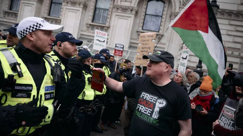 Protesters face a line of police in central London at a national demonstration for Palestine, on 18 January 2025 (Benjamin Cremel/AFP)