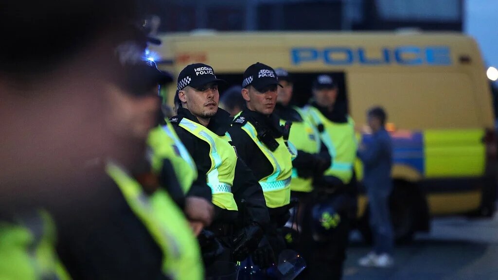 Police officers stand guard amid a demonstration outside the Abdullah Quilliam Mosque in Liverpool, England, on 2 August 2024 (Ian Cooper/AFP)