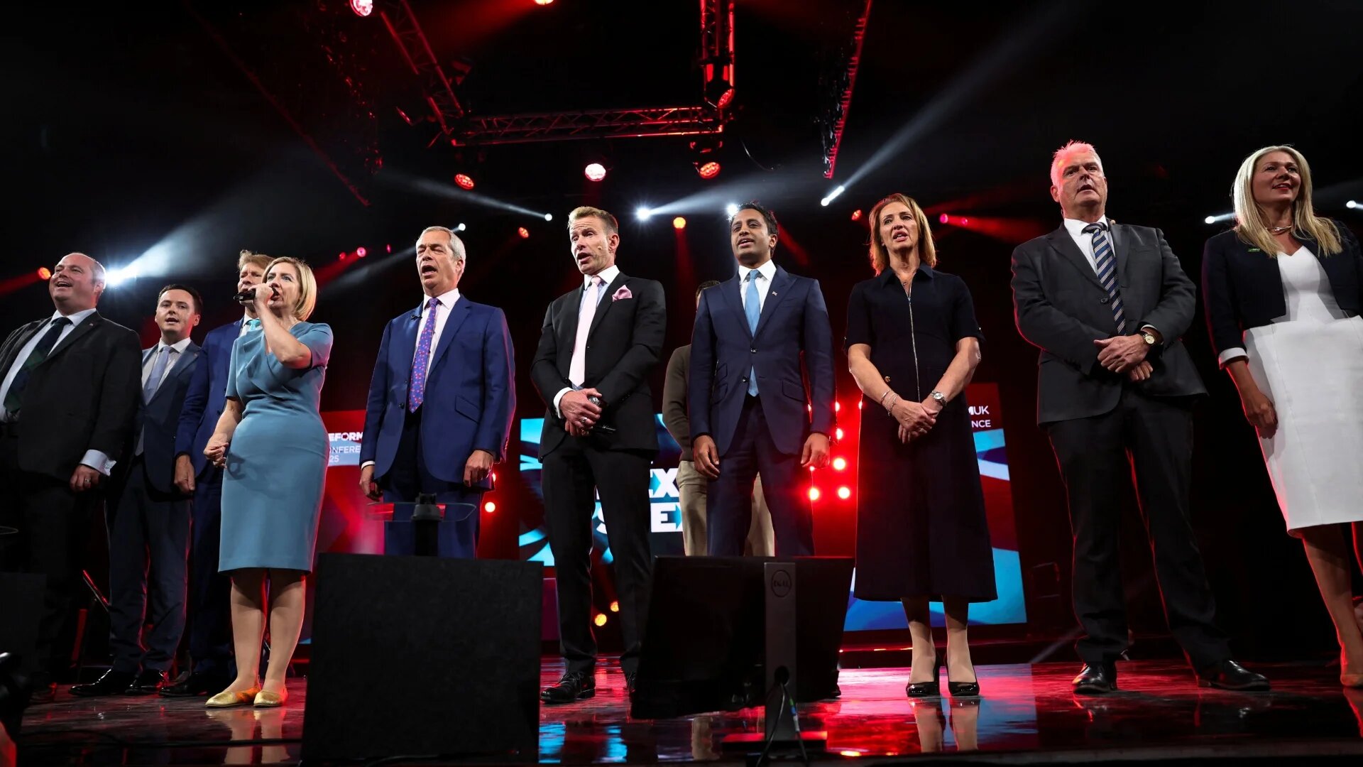 Reform UK party leader Nigel Farage and other senior party members sing the national anthem at the annual party conference in Birmingham on 6 September 2025 (Phil Noble/Reuters)