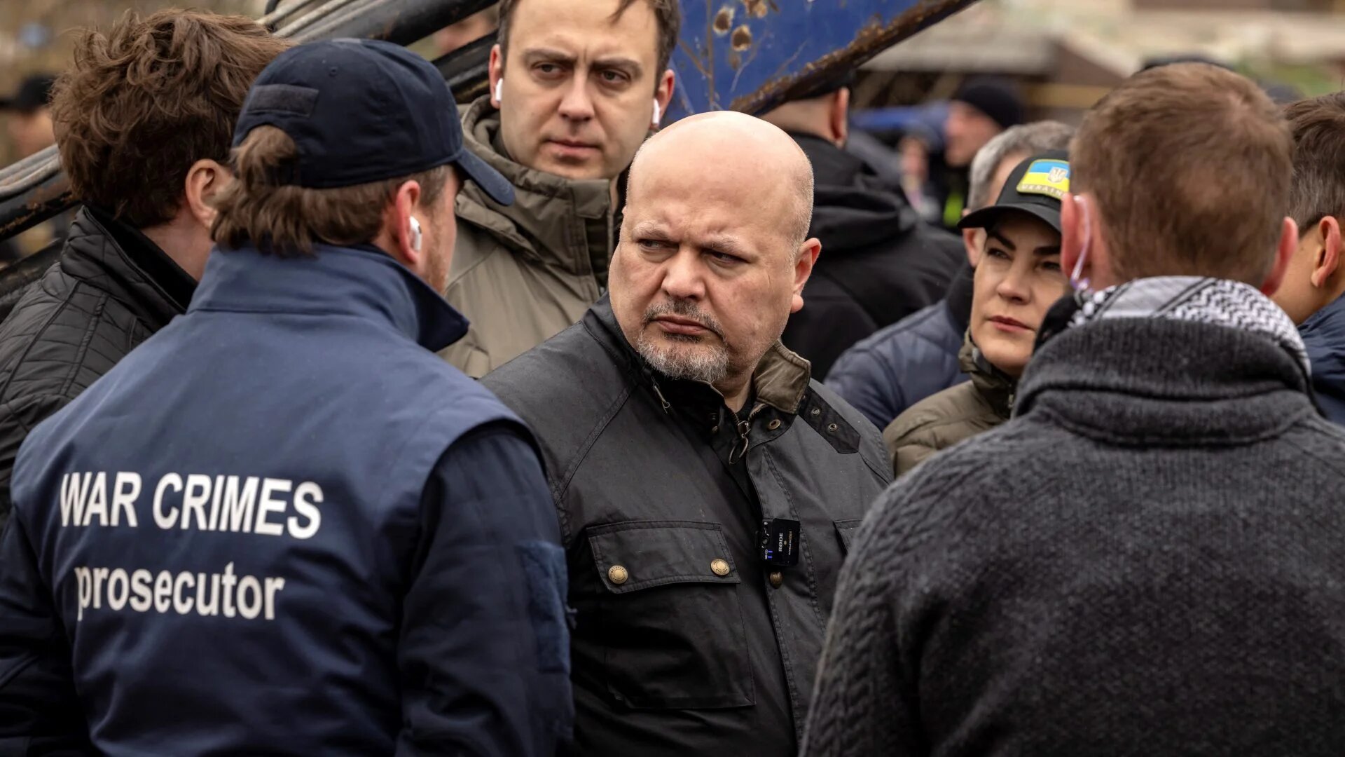 Prosecutor of the International Criminal Court, Britain's Karim Khan (centre), visits a mass grave in Bucha, near Kyiv, Ukraine, on 13 April 2022 (Fadel Senna/AFP)