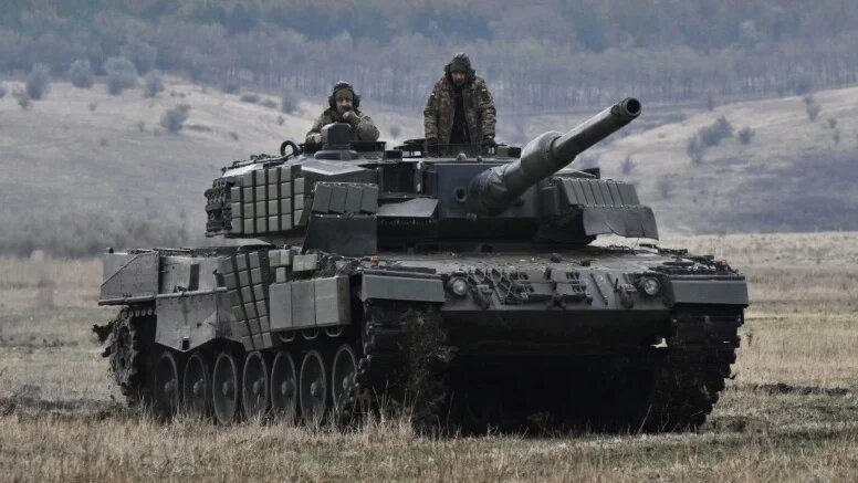 Ukrainian forces ride on a tank during field training on 27 October 2024 (Genya Savilov/AFP)
