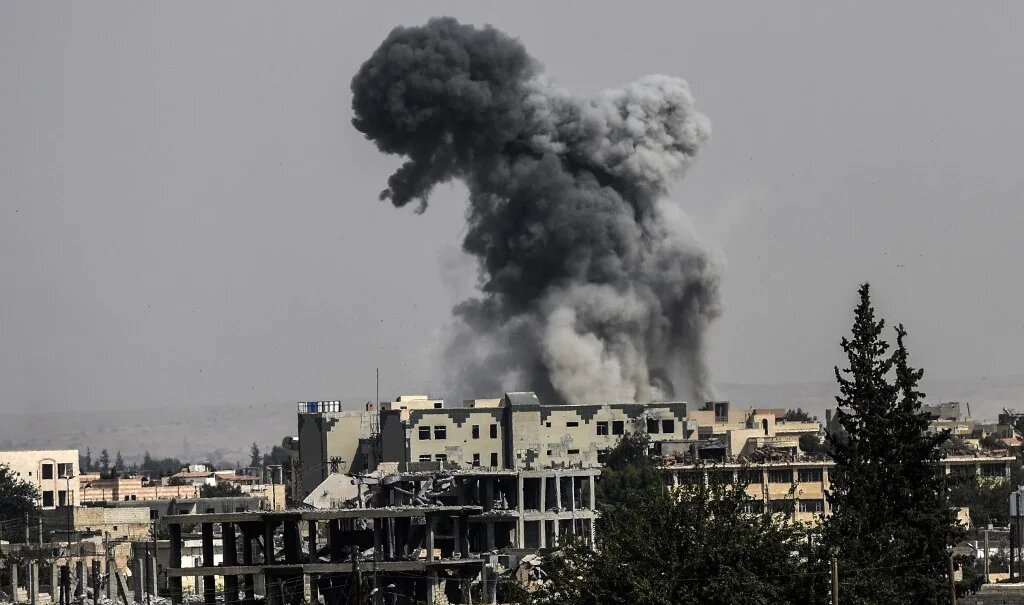 Smoke billows following an air strike on the western frontline of Raqqa on 17 July 2017.
