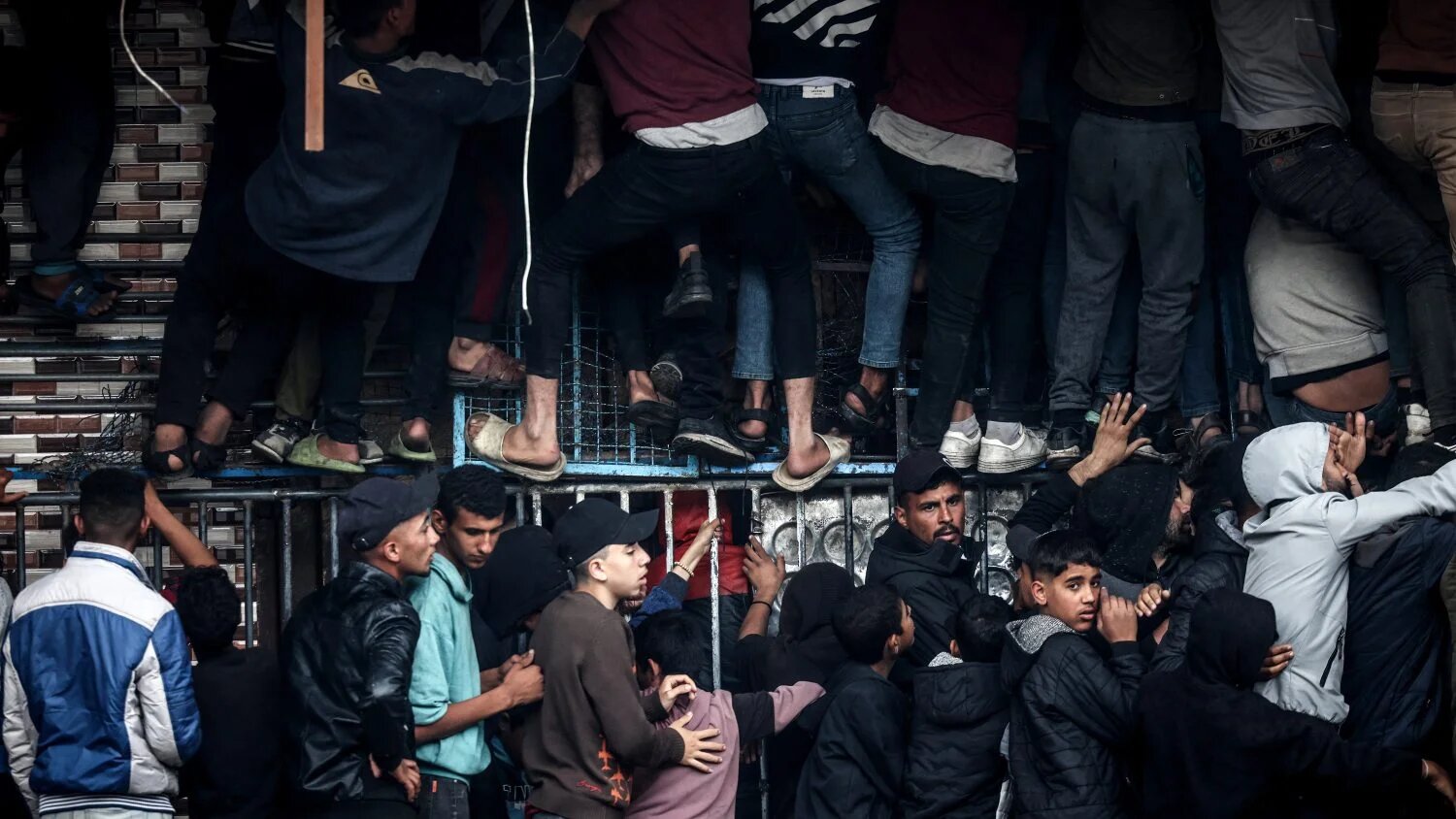 Palestinians crowd oustide a bakery to buy bread in Rafah in southern Gaza on 15 February 2024.