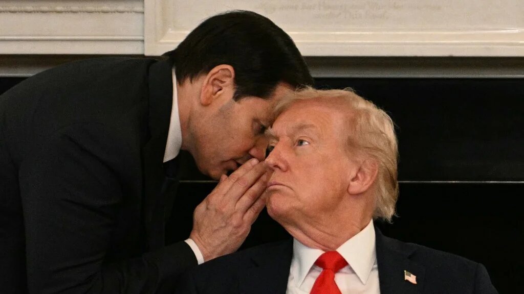 US Secretary of State Marco Rubio whispers in the ear of President Donald Trump during a roundtable at the White House in Washington, DC, on 8 October 2025 (Jim Watson/AFP)