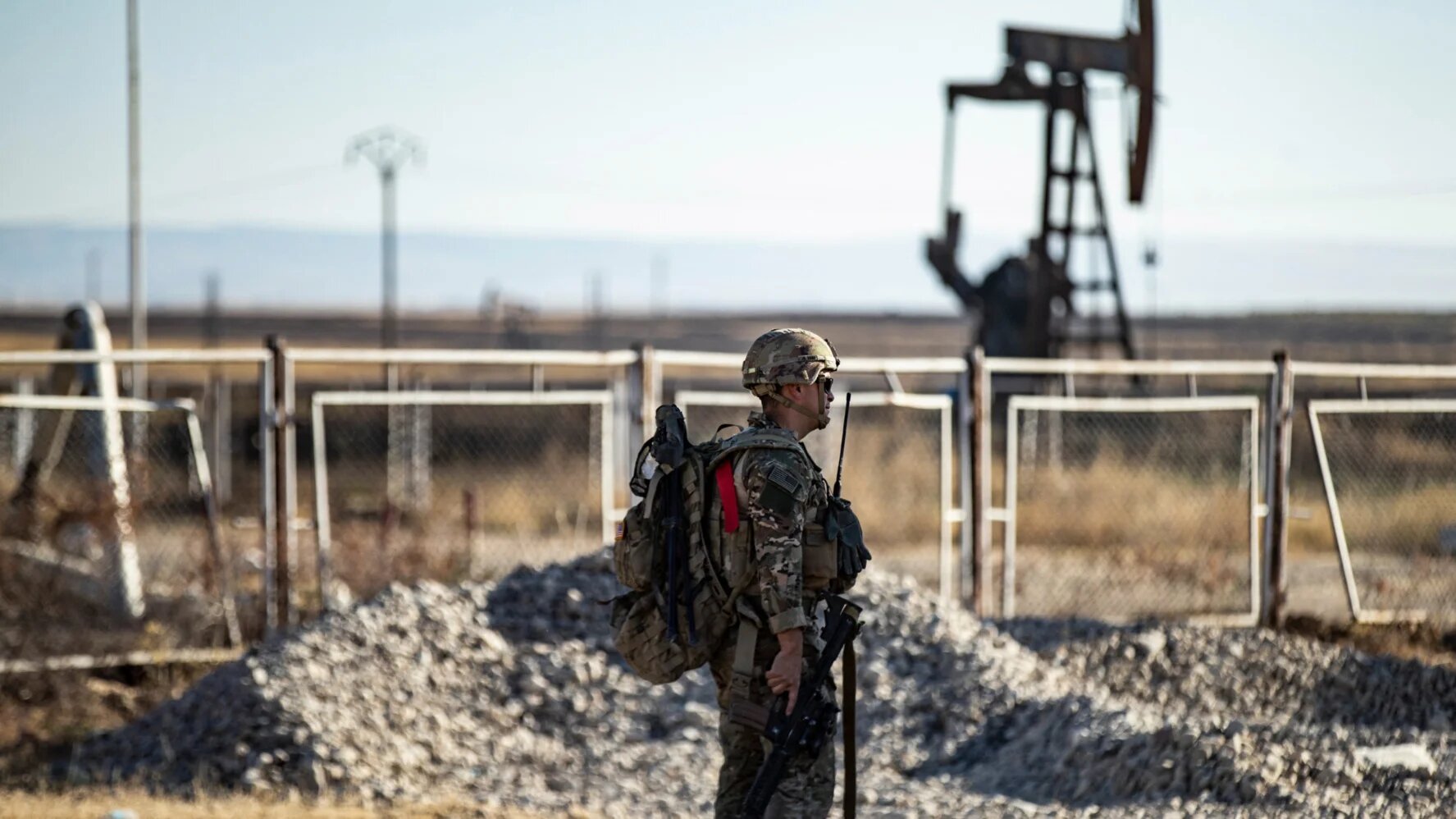 A US soldier monitors the area as troops patrol oil fields near Syria's northeastern border with Turkey in the Qahtaniyah countryside, al-Hasakah on 3 September 2024 (Delil Souleiman/AFP)