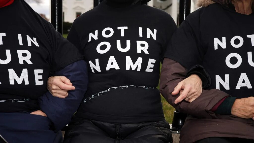 Activists chain themselves to the fence of the White House in Washington at a protest organised by Jewish Voice for Peace against the Gaza war on 11 December 2023 (Alex Wong/Getty Images/AFP)